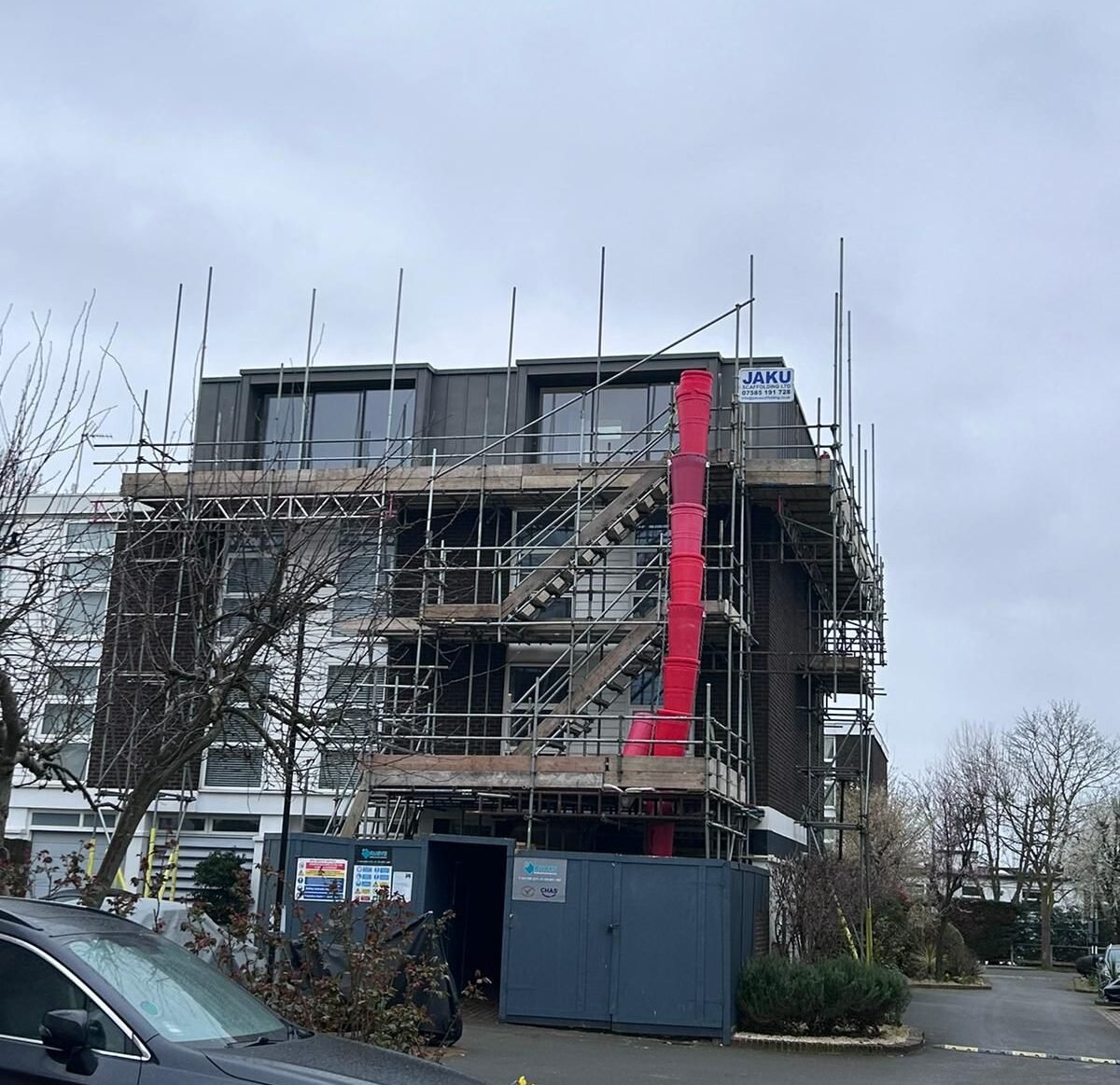 Engineers designing a safe and compliant scaffolding system for a residential property in London.